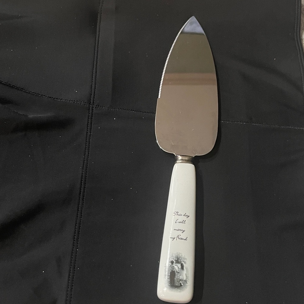 Elegant Stainless Steel Wedding Cake Server with White Handle and Script.